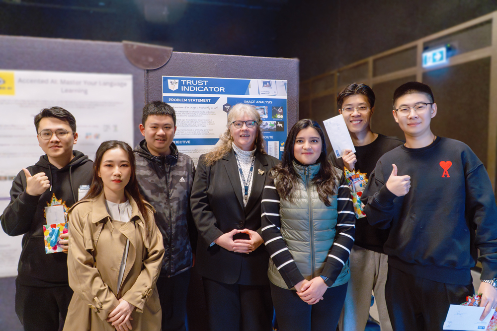 Trust Indicator TechLauncher team – From left to right, Zhaoyun Zhang, Lingxiu Cai, Tony Chen, Dr. Sabrina Caldwell, Vidhu Chaudhary, Yifang Meng and Song Han, Photo edited by Lingxiu
