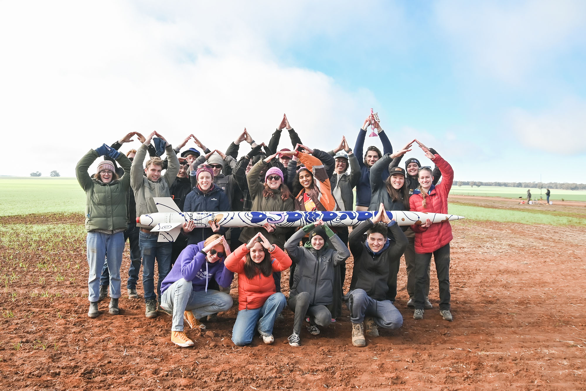 The ANU Rocketry team with their rocket Garawaηa
