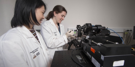 PhD scholar Sherry He and Dr Samantha Montague, from the Australian National University, work with their diagnostic device that reveals the formation of blood clots in patients.