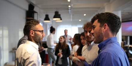 People talk to each other in a networking event. 