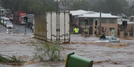Woman on car during flash flooding in Toowoomba